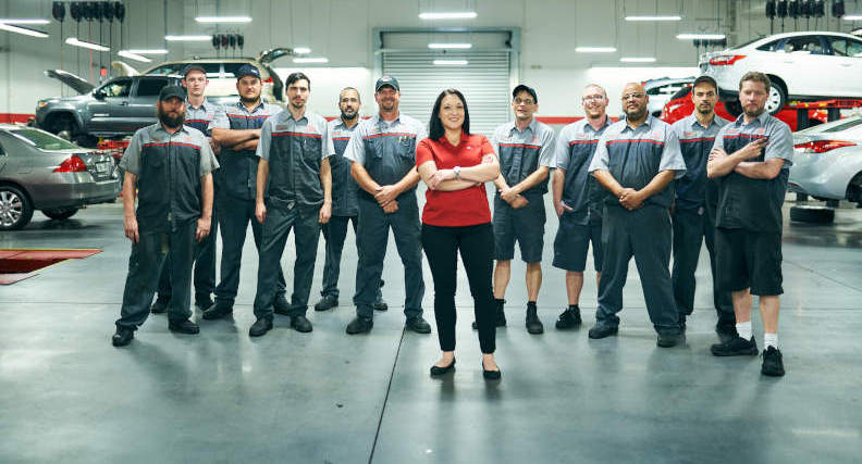 Lakeland Toyota auto service team standing in garage for Synchrony Car Care success story photo.