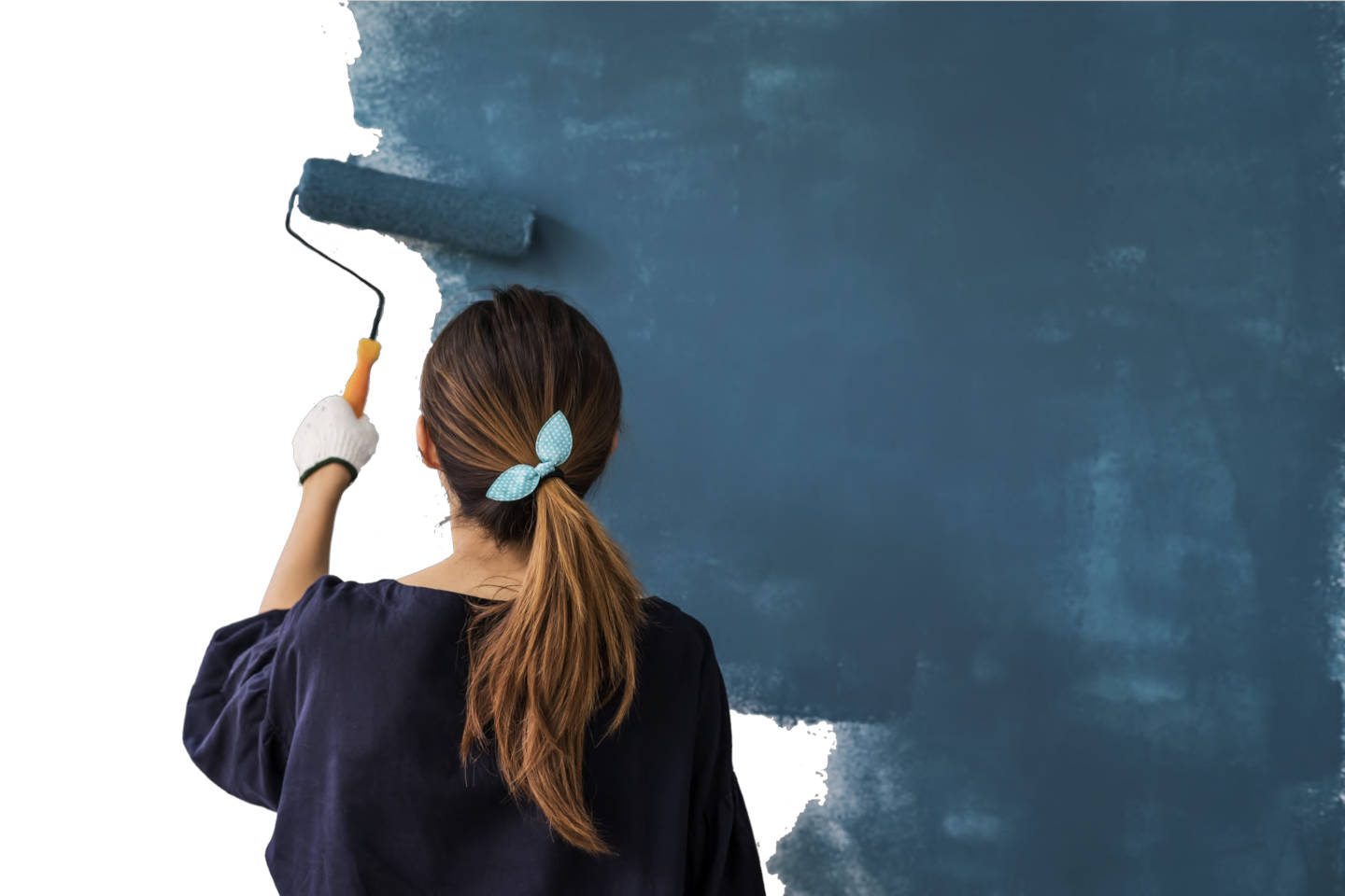 Female store associate painting a wall blue.